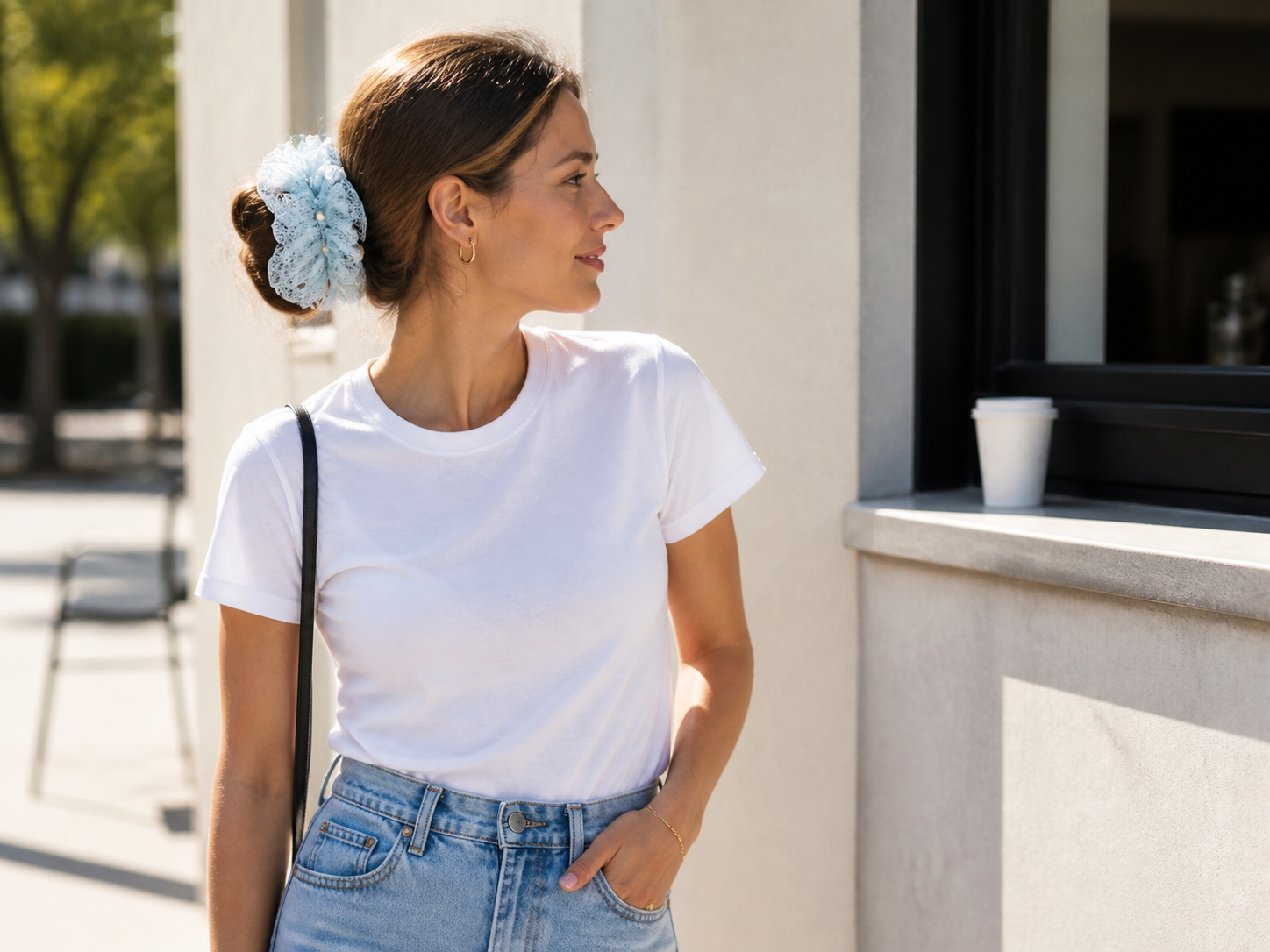 Woman styling an ice blue statement scrunchie with a simple outfit