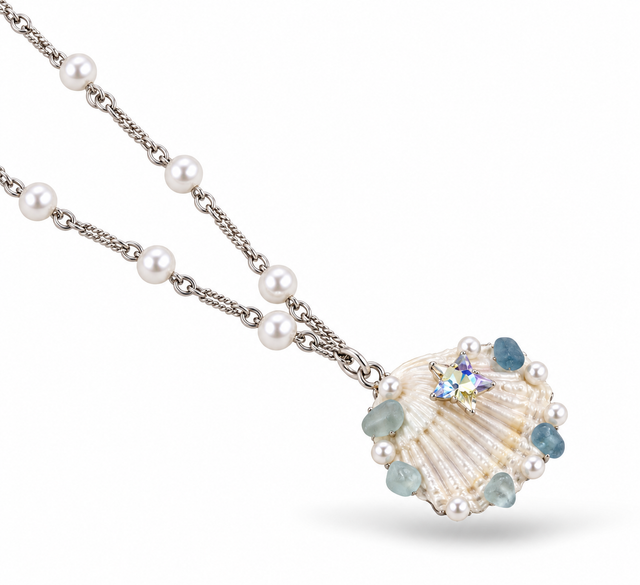 Alternate angled view of the pearl chain and decorated shell pendant.