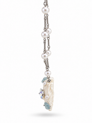 Side profile of the white seashell pendant and aqua bead details.