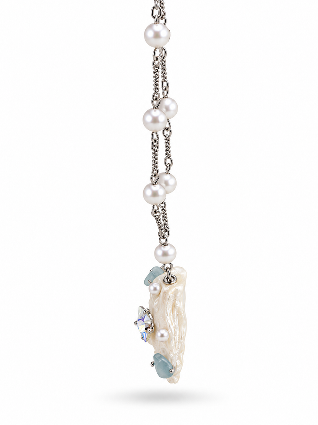 Side profile of the white seashell pendant and aqua bead details.