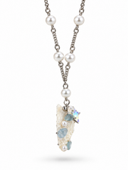 Opposite side view of the seashell pendant and pearl chain.