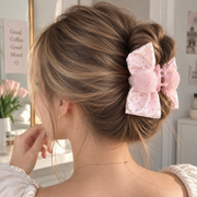 Pink rose bow hair claw clip styled in an everyday hairstyle