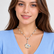 Woman wearing the pearl and aqua seashell pendant necklace.