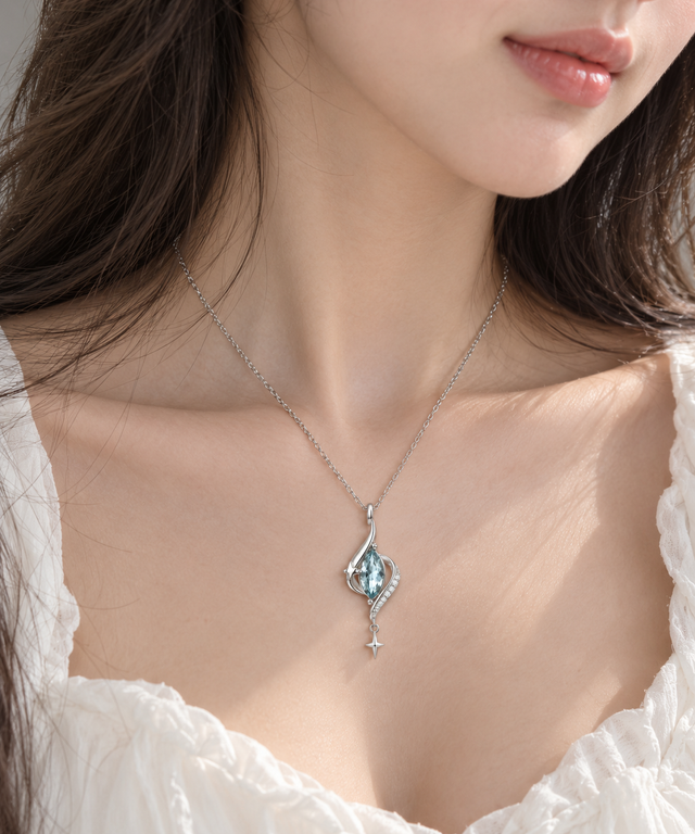 Woman wearing the silver-tone aqua teardrop pendant necklace.