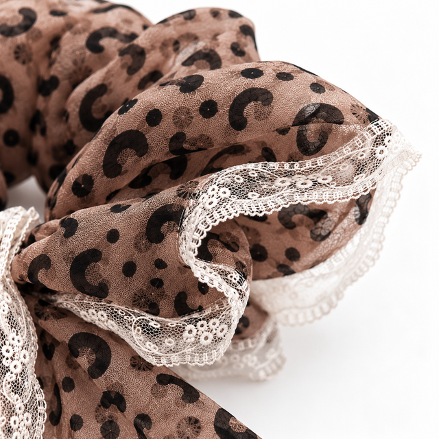 Close-up of gathered leopard chiffon and floral lace edging