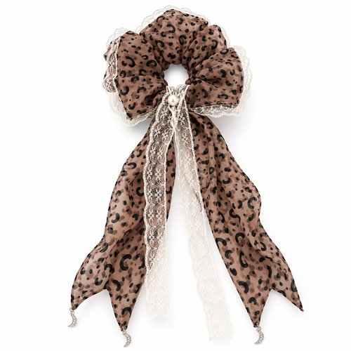 Leopard lace ribbon scrunchie with pearl-look accent on a white background