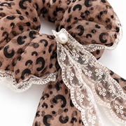 Pearl-look center and ivory lace detail on the leopard ribbon scrunchie