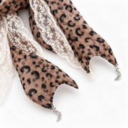Crescent-shaped charms on the leopard lace ribbon scrunchie