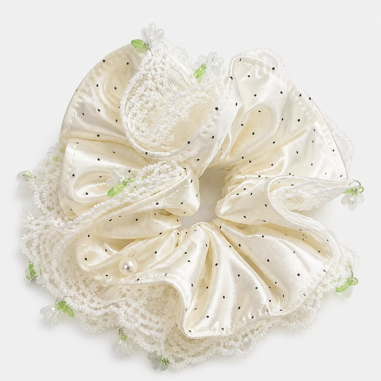 Ivory polka-dot satin and lace oversized scrunchie on a neutral gray-white studio background