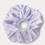 Pale lilac floral pearl satin oversized scrunchie on a neutral gray-white studio background